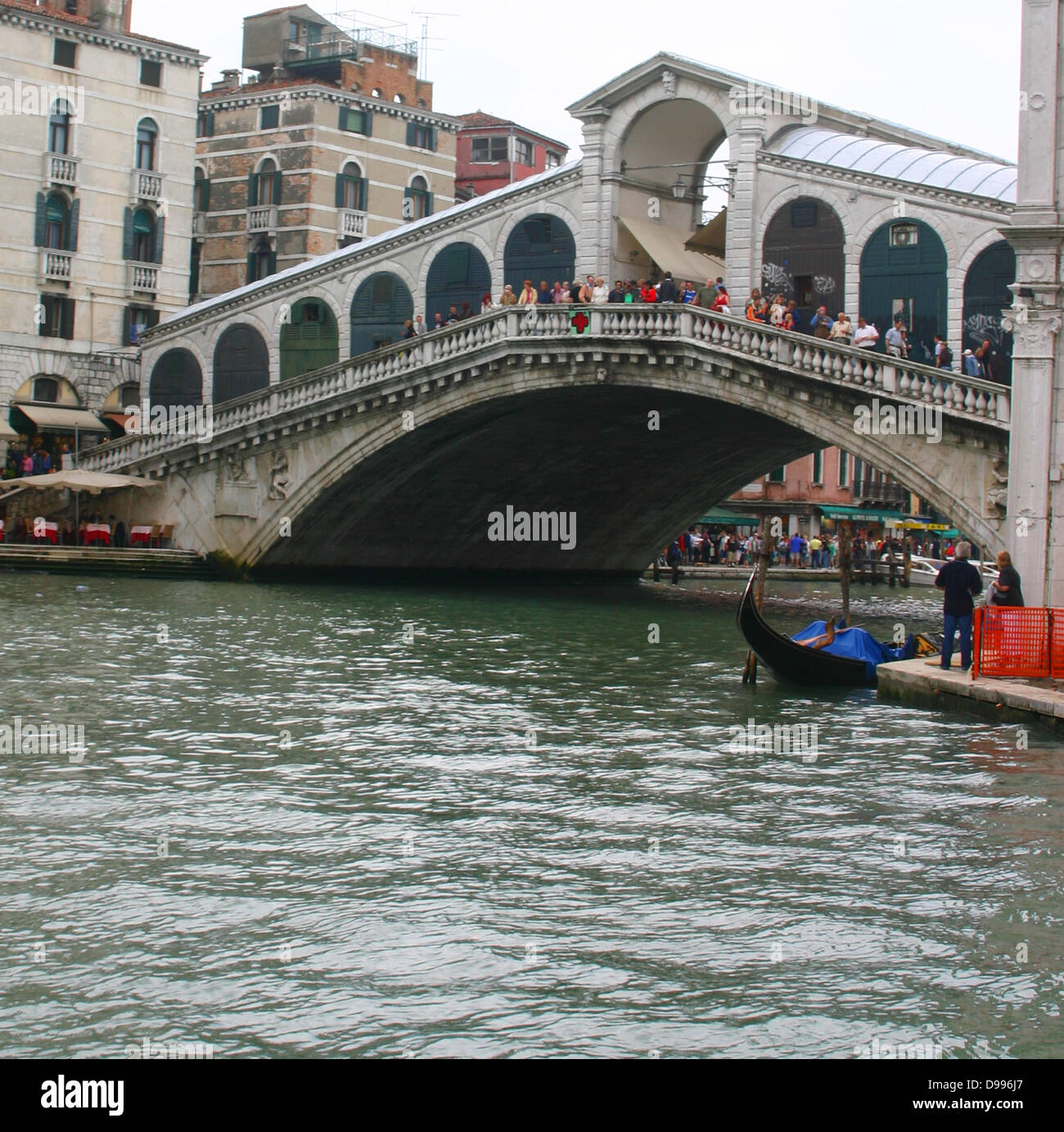 The Rialto Bridge (Italian: Ponte di Rialto) is one of the four bridges spanning the Grand Canal in Venice, Italy. It is the oldest bridge across the canal. The present stone bridge, a single span designed by Antonio da Ponte, was finally completed in 1591. Stock Photo