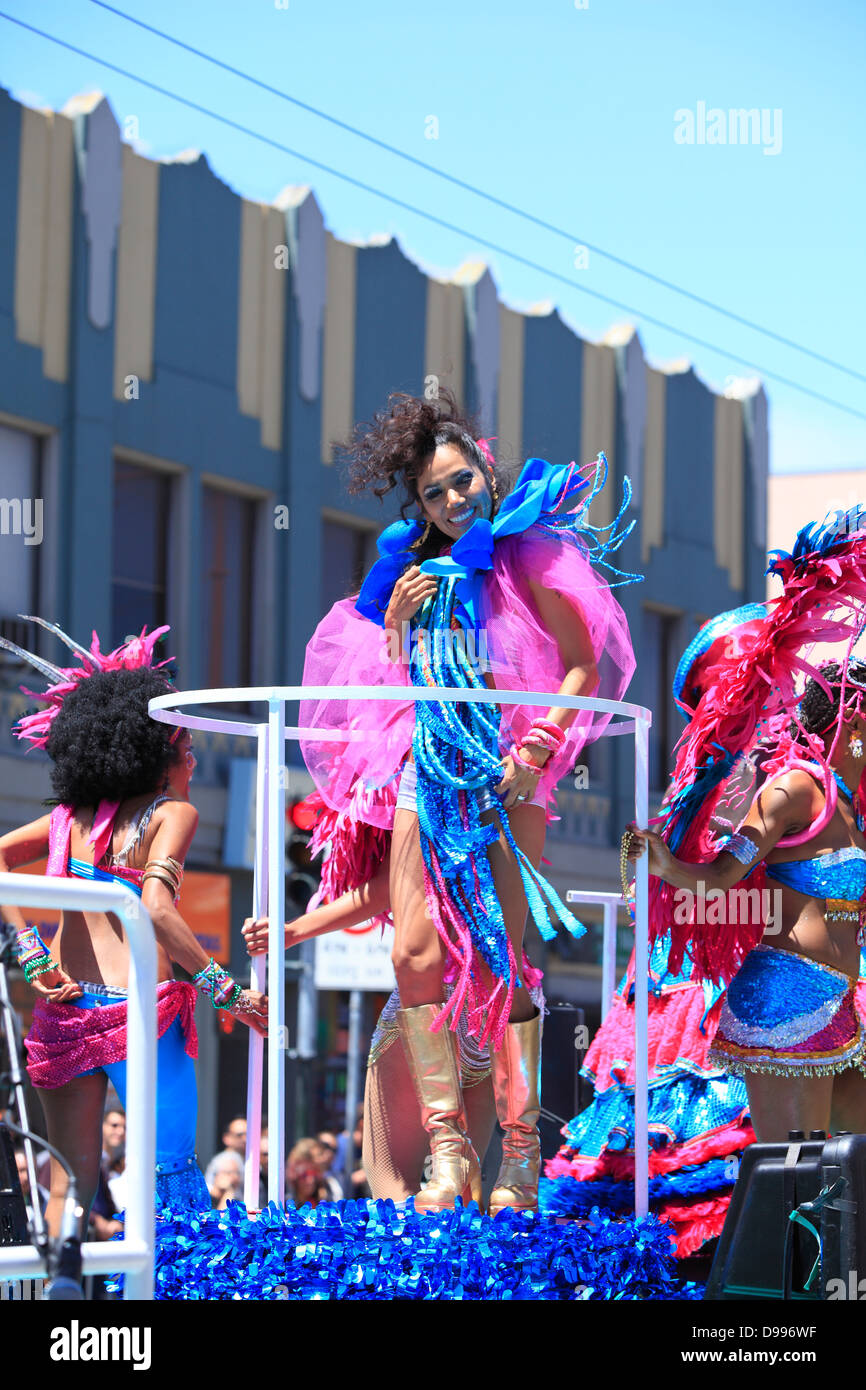 Colorful and spirited dancers on a float during carnaval parade in Mission District, San Francisco, California, USA Stock Photo