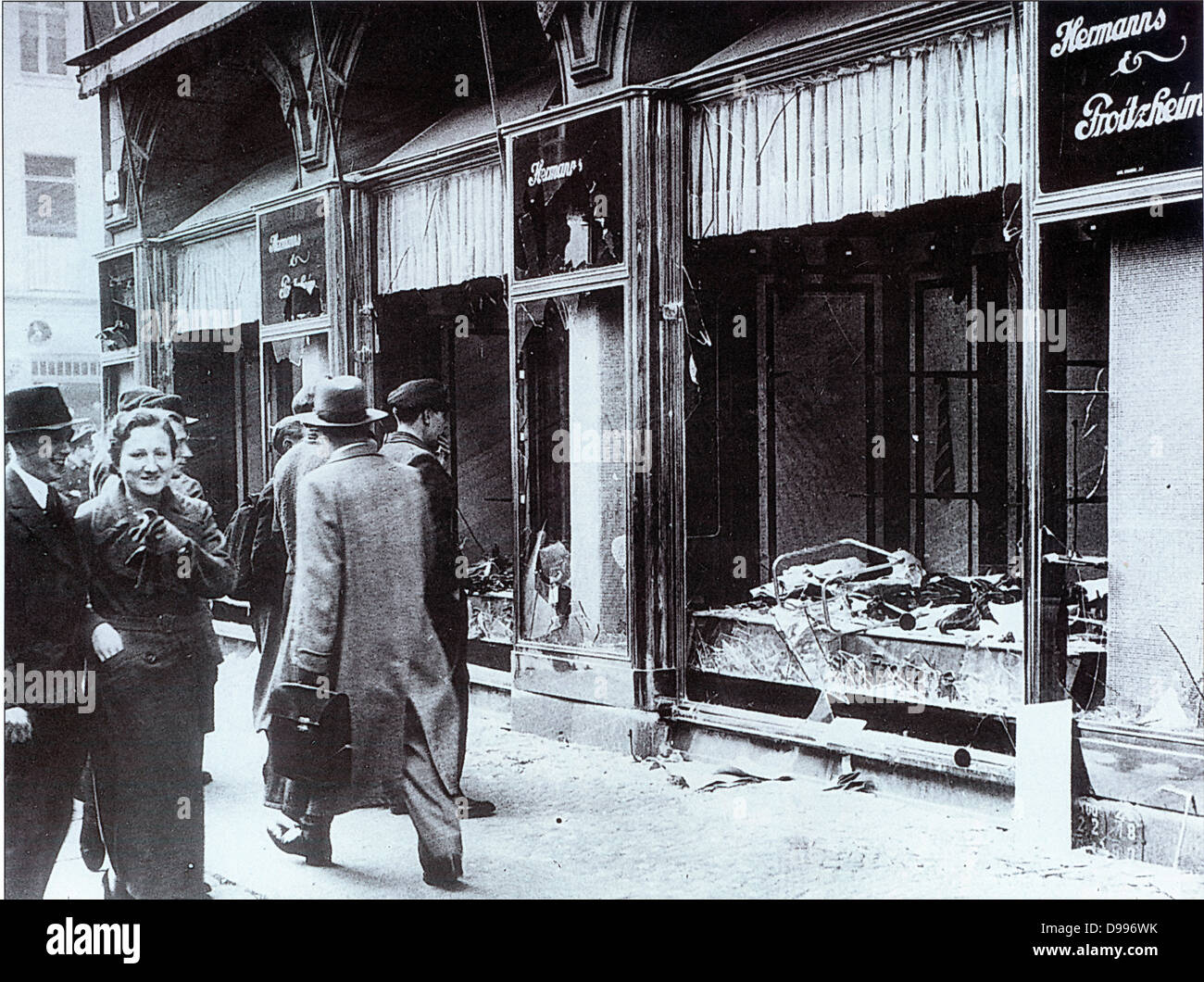 Pedestrians glance at the broken windows of a Jewish owned shop in Berlin after the attacks of Kristallnacht, November 1938 Stock Photo