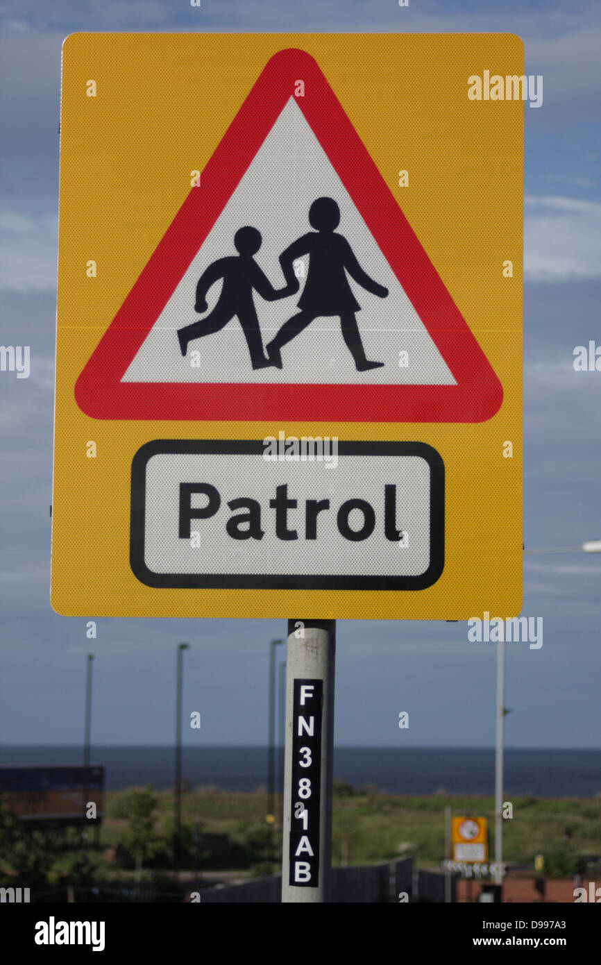 School Patrol - Road traffic sign, warns motorists about children coming and going to and from school. Portrait, central. Stock Photo