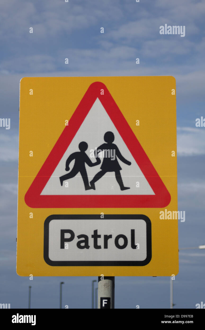 School Patrol - Road traffic sign, warns motorists about children coming and going to and from school. Portrait, Lower center. Stock Photo