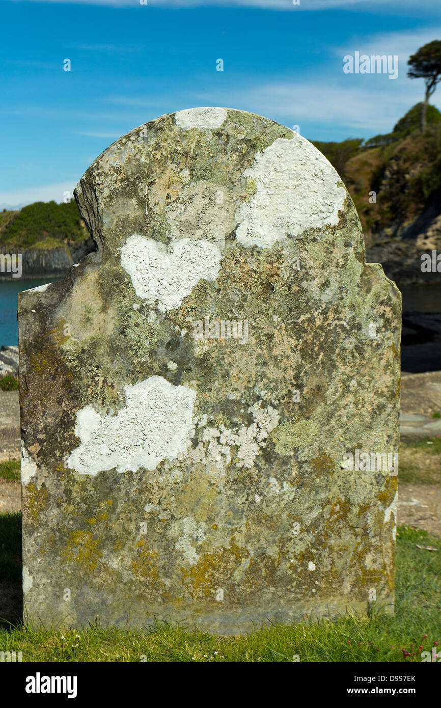 Old gravestones covered in lichen at St. Brynach's Church, Wales Stock Photo