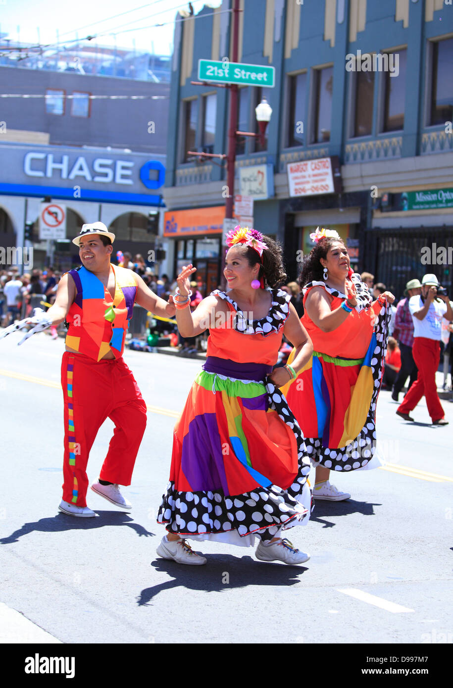 Dancers sashaying down Mission District during Carnaval parade in San Francisco, California, USA Stock Photo