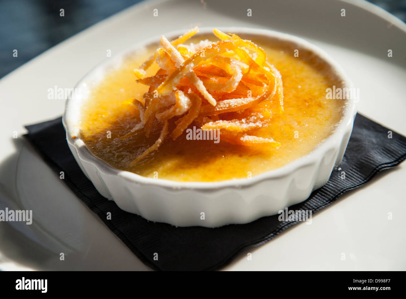 single serving of cream brulee topped with orange Stock Photo