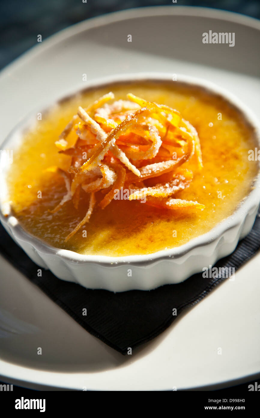 single serving of cream brulee topped with orange Stock Photo