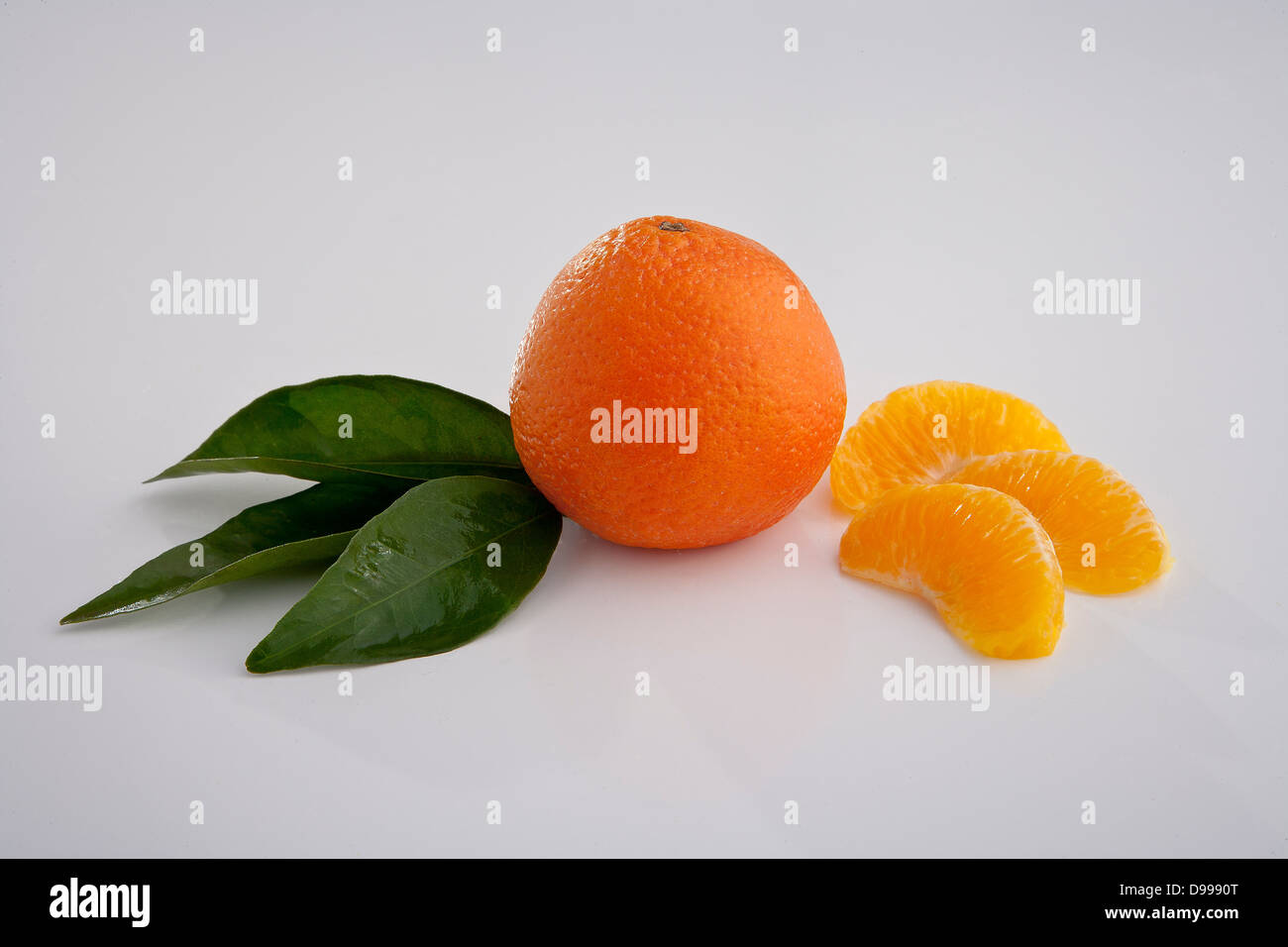 oranges and orange wedges on white Stock Photo