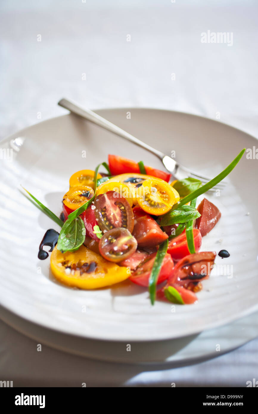 heirloom tomato salad with fresh sage in a bowl Stock Photo