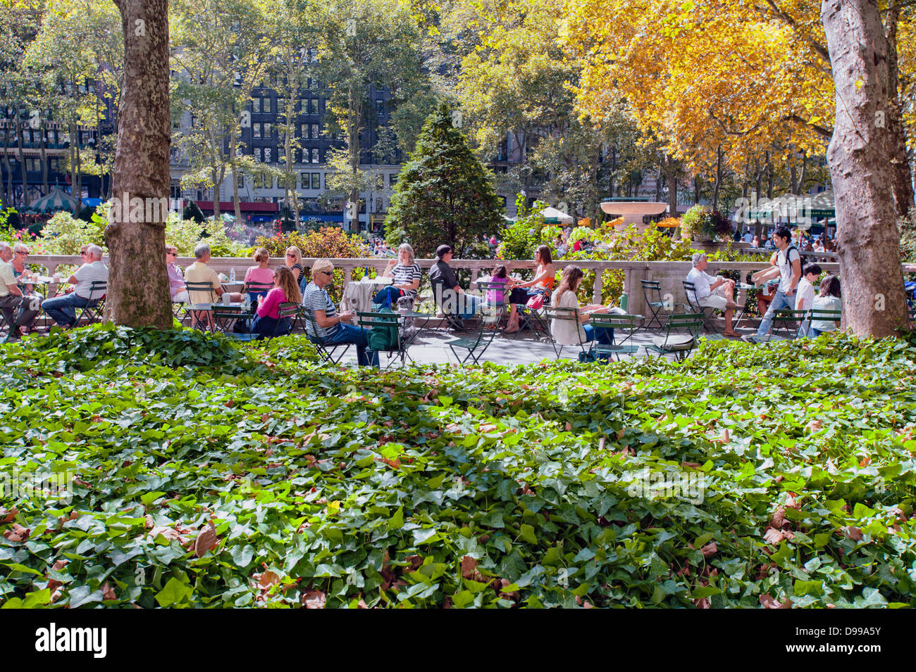 People relaxing and having a good time in a city park. Stock Photo