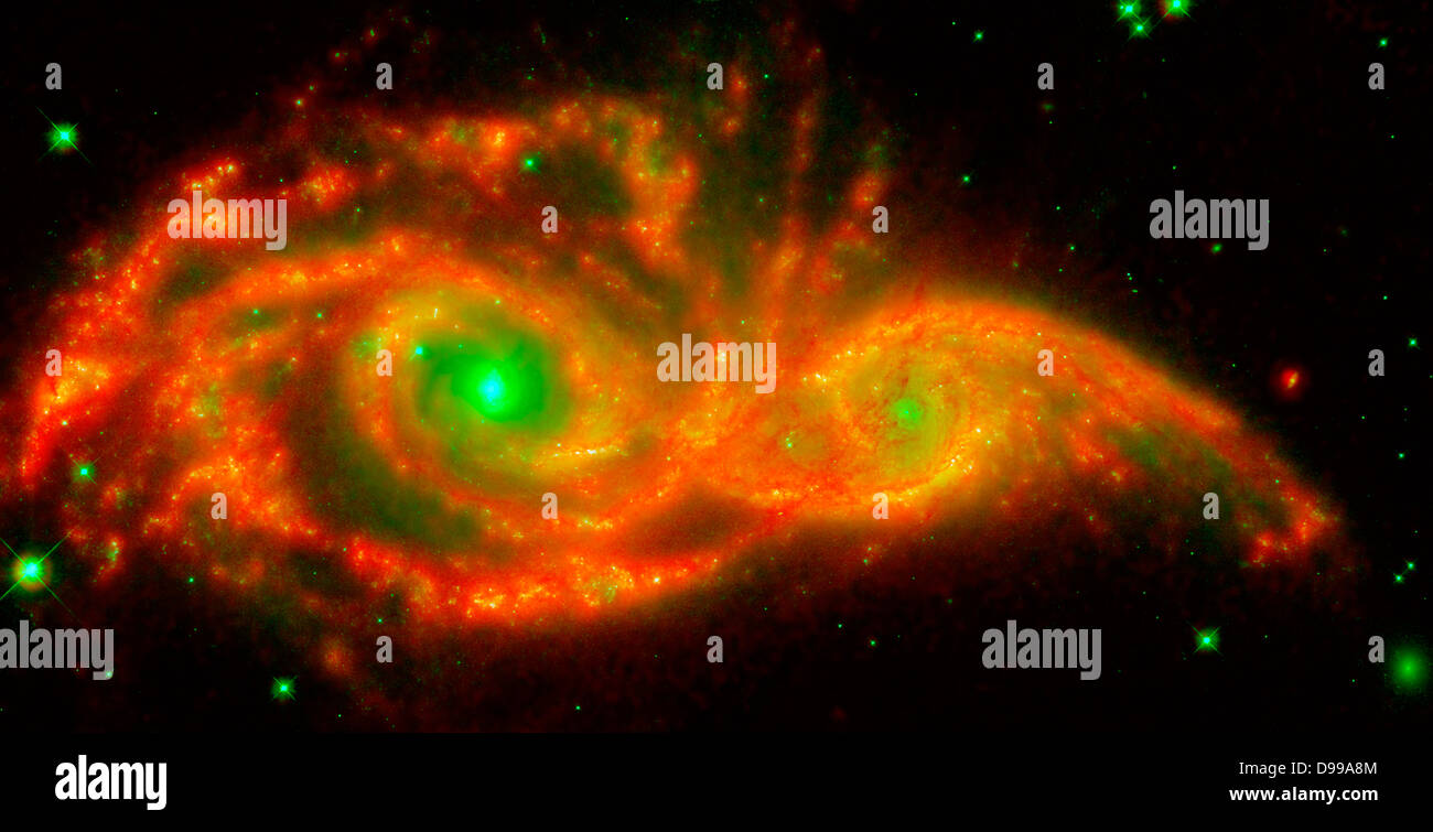 NGC 2207 and IC 2163 met and began a sort of gravitational tango about 40 million years ago. The two galaxies are tugging at each other, stimulating new stars to form. Eventually, this cosmic ball will come to an end, when the galaxies meld into one. The dancing duo is located 140 million light-years away in the Canis Major constellation. Hubble Space Telescope (HST),Spitzer Space Telescope. Stock Photo