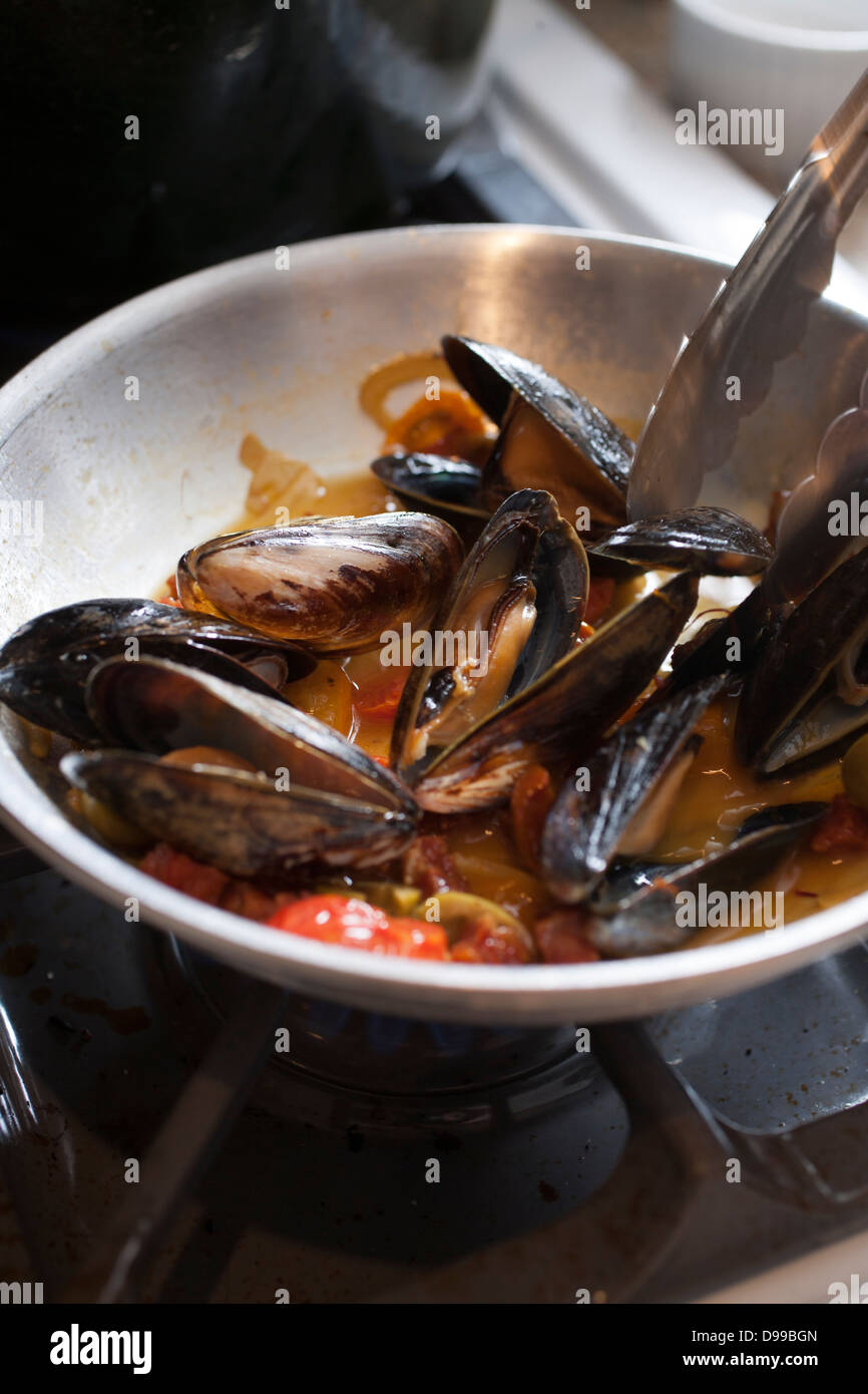 mussels sauteing in butter and garlic Stock Photo