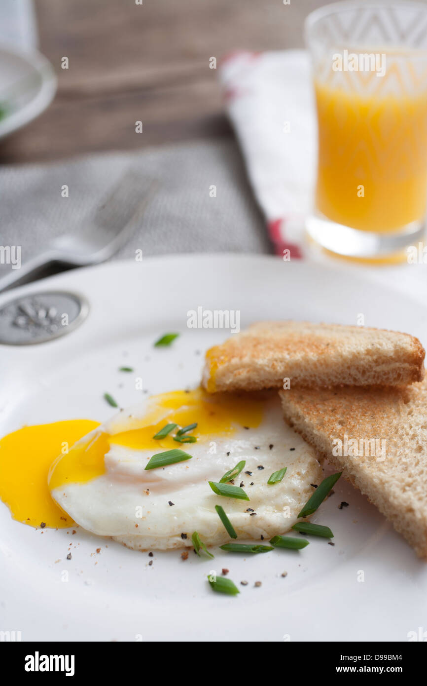 fried egg and toast with orange juice Stock Photo
