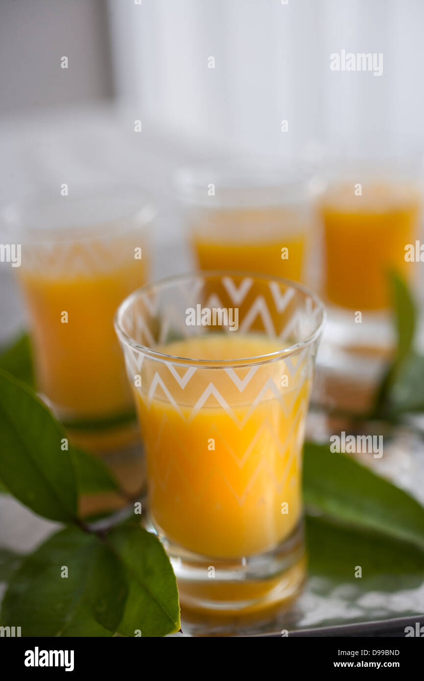 4 glasses of fresh squeezed orange juice on a serving tray Stock Photo