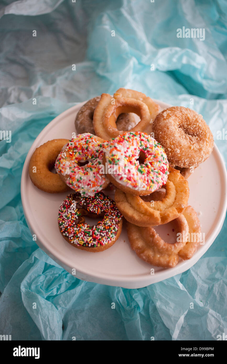 dozen colorful donuts on a plate Stock Photo