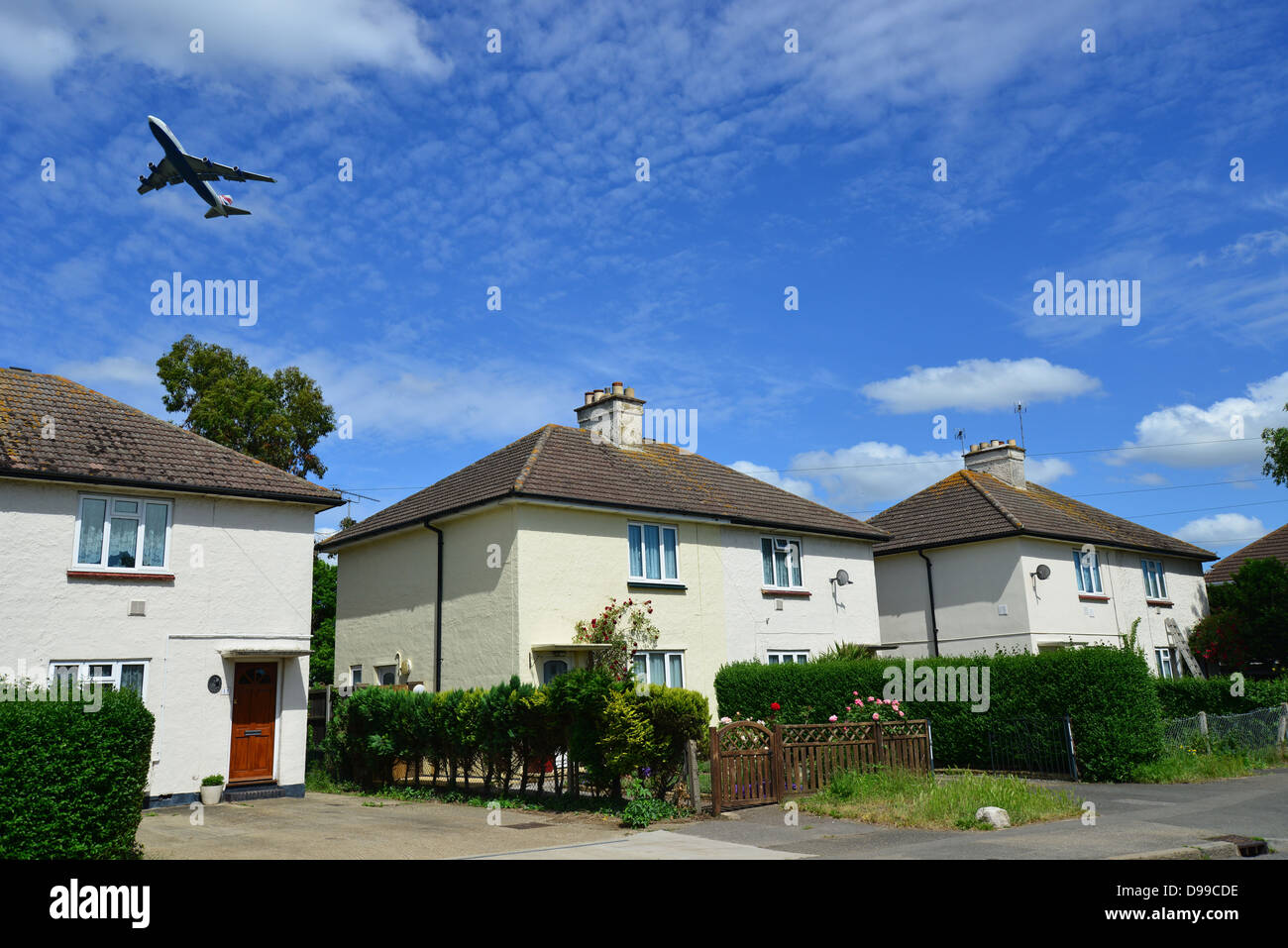 Aircraft taking off from Heathrow Airport over houses, Horton Road, Stanwell Moor, Surrey, England, United Kingdom Stock Photo