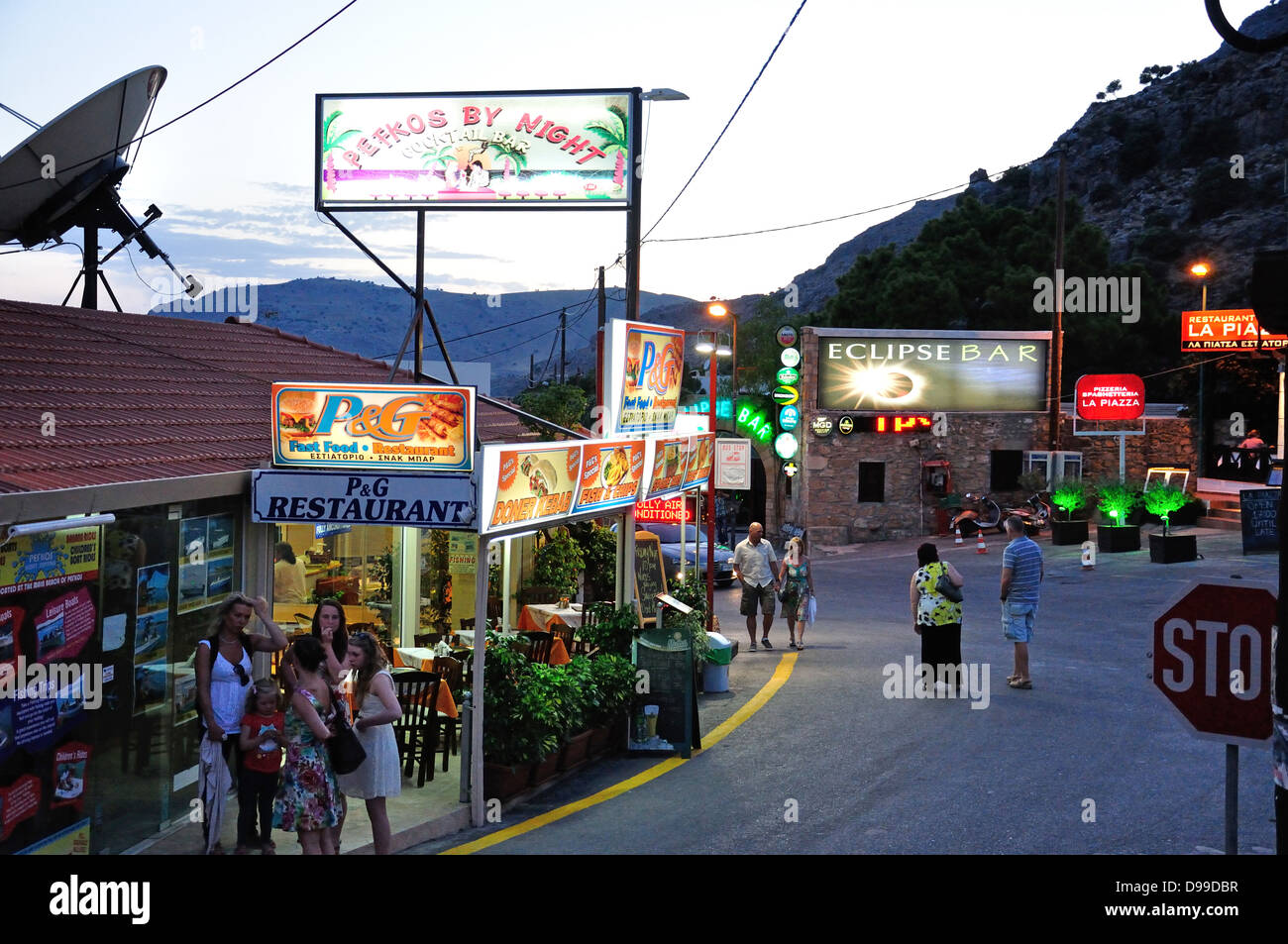 Neon bar signs at dusk, Pefkos, Rhodes (Rodos), The Dodecanese, South Aegean Region, Greece Stock Photo