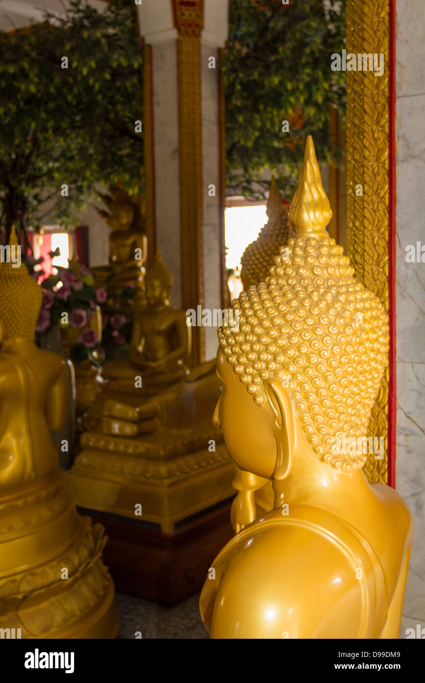 Gold coloured stature at temple in PHUKET, THAILAND - JUN 14, 2011: Stock Photo