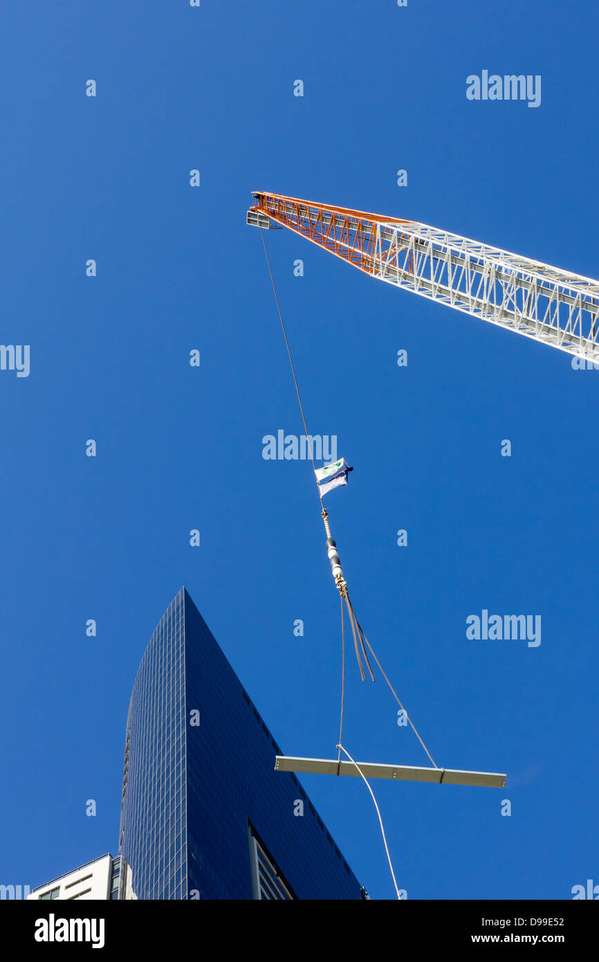 Crane lifting steel beam at construction site Stock Photo Alamy