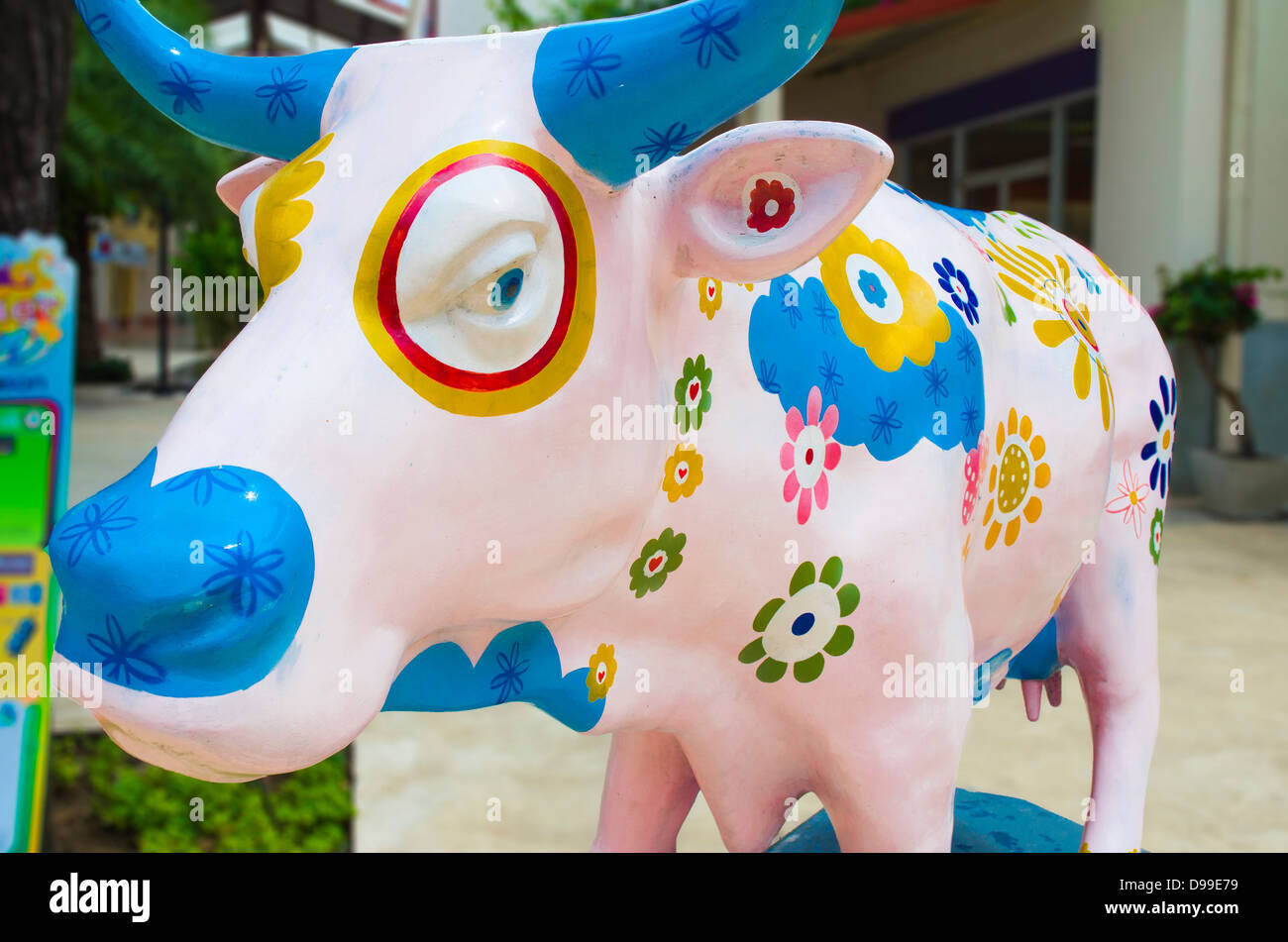 Artificial Cow with Colourful Painting Flowers Stock Photo