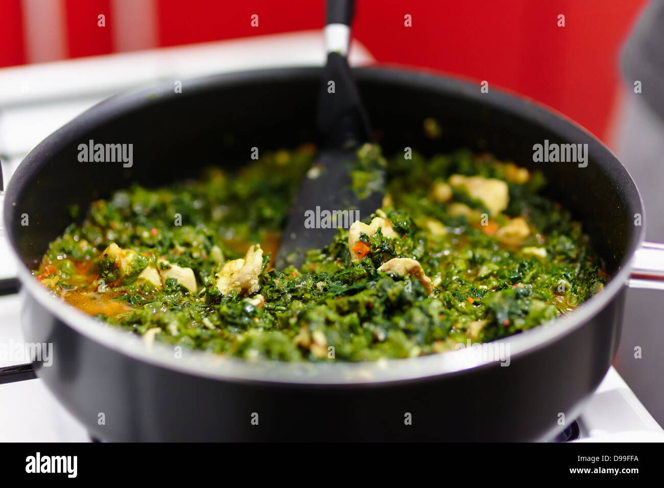 Spinach cooking in a pan on the gas stove Stock Photo Alamy