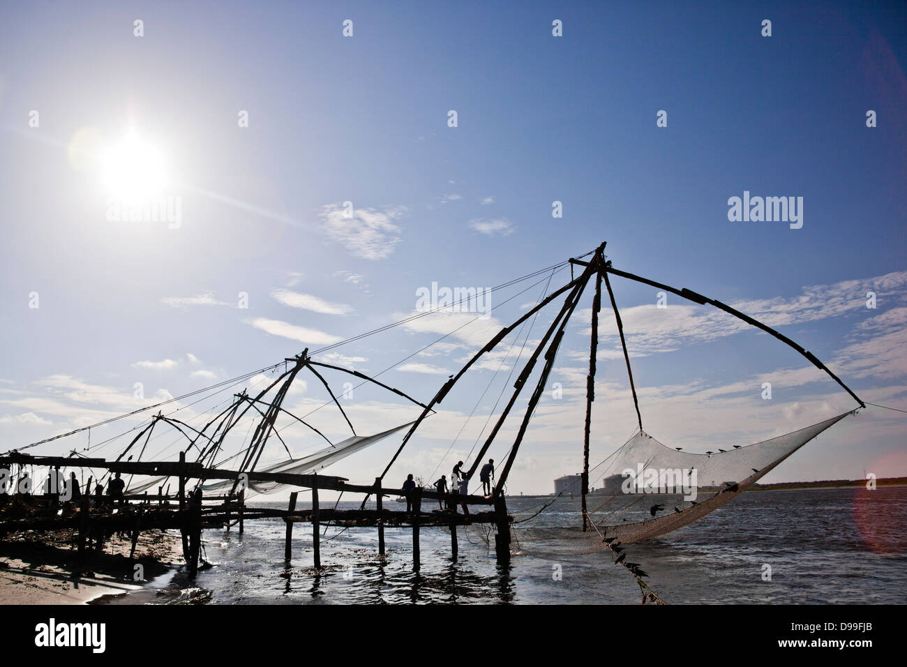 Fishermen with Chinese fishing nets at a harbor, Cochin, Kerala, India Stock Photo