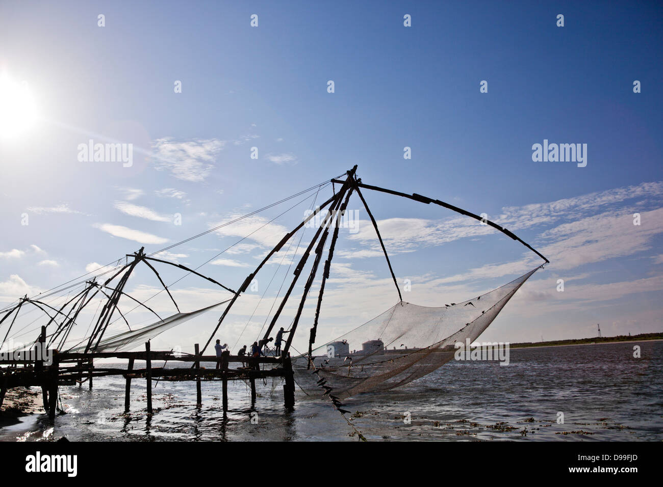 Fishermen with Chinese fishing nets at a harbor, Cochin, Kerala, India Stock Photo