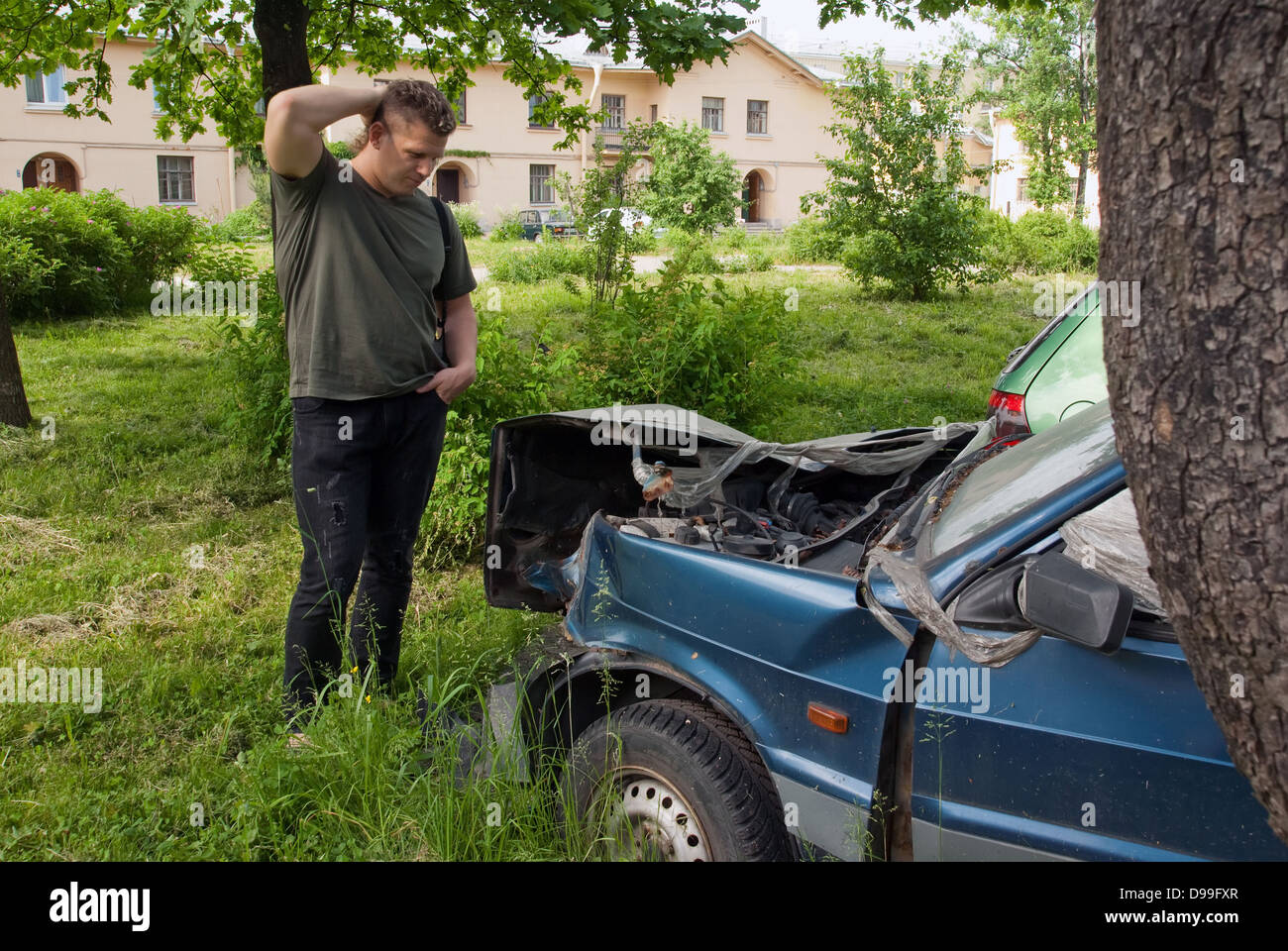 The puzzled man stands next to the broken machine Stock Photo - Alamy