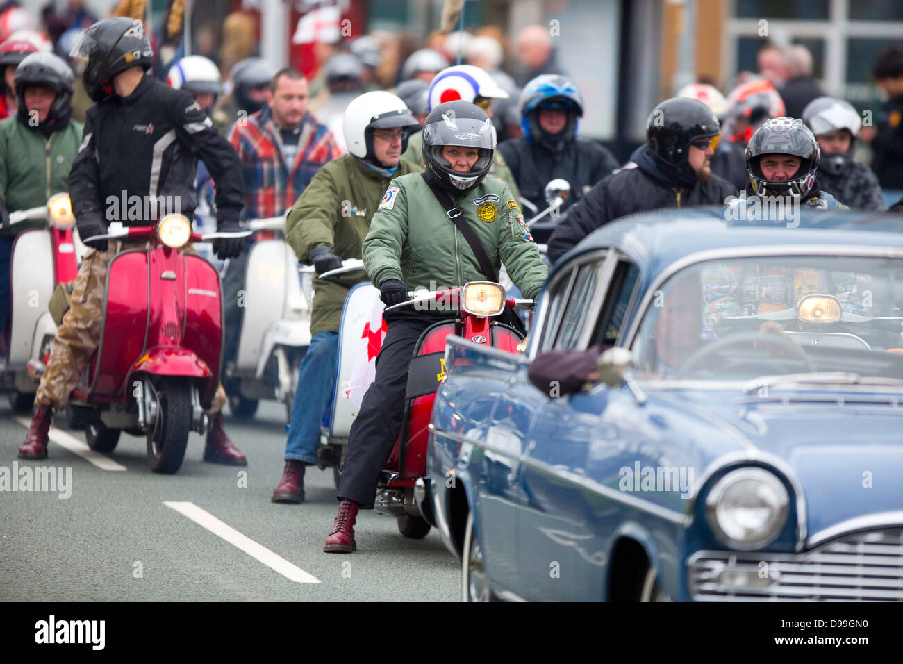 The 10th St Georges day parade on Oldham Street Manchester a Vauxhall Cresta leads a Vespa scooter bike club Stock Photo