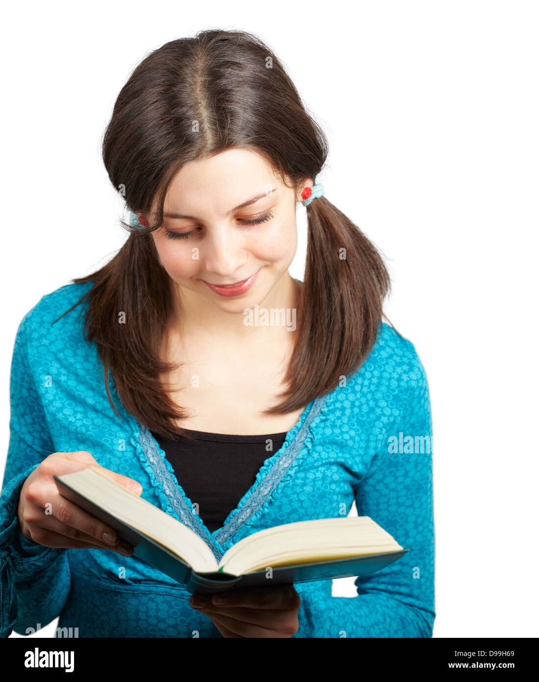 Young teenage girl reading from a book isolated over white background