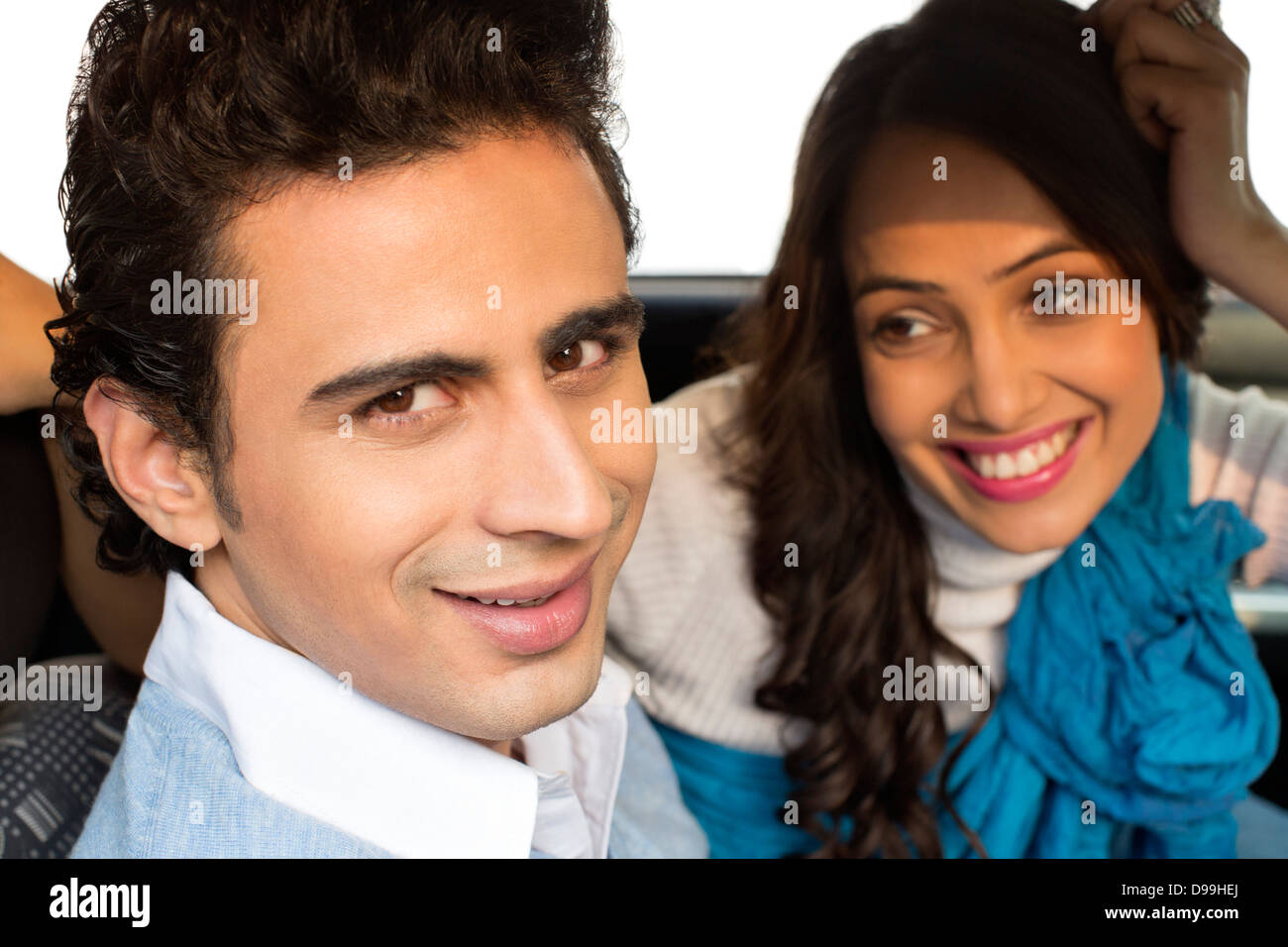 Couple sitting in a car and smiling Stock Photo