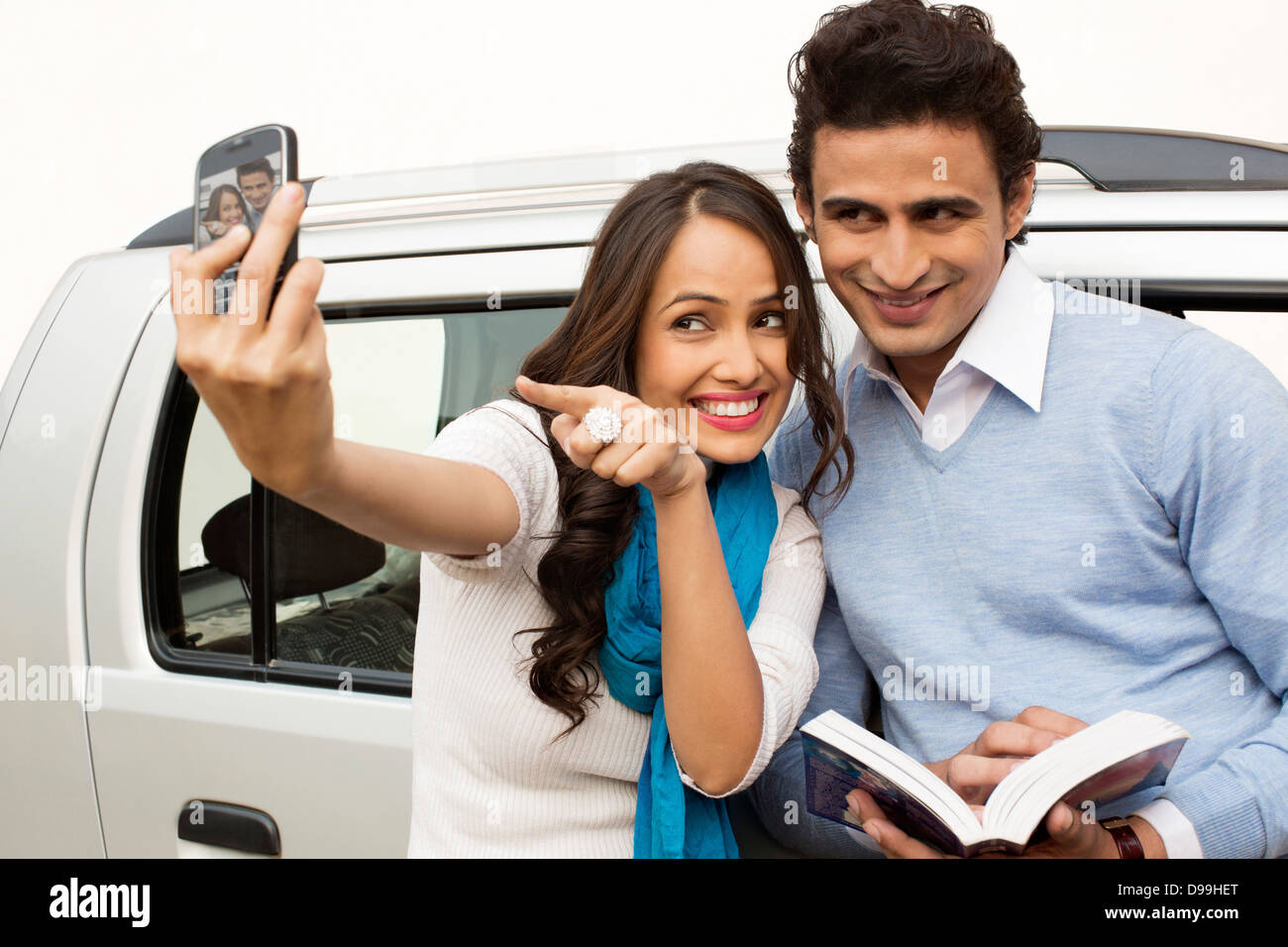 Couple taking picture of themselves with a mobile phone Stock Photo