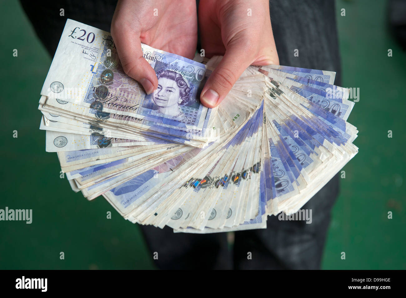 person holding three thousand pounds cash fanned Stock Photo