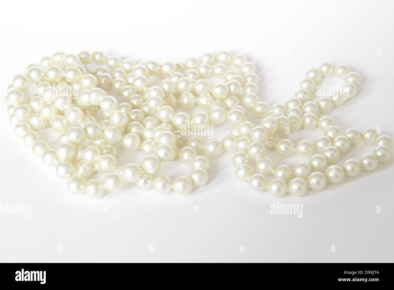 White Pearl Beads On A White Background Stock Photo, Picture and Royalty  Free Image. Image 65558619.