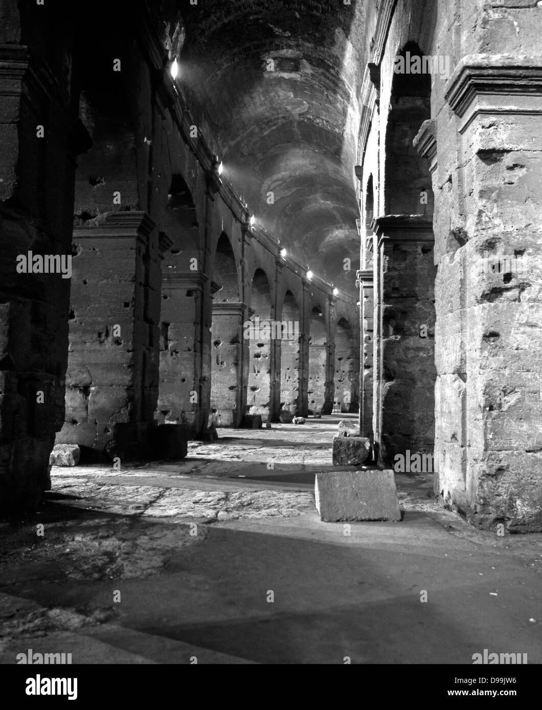 Underneath the arches of the Colosseum at night, Rome, Lazio, Italy, Europe. Stock Photo