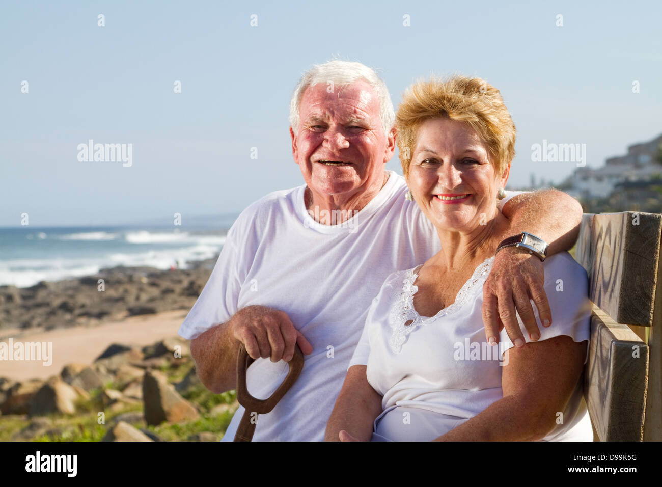 happy senior couple sitting on beach bench Stock Photo - Alamy