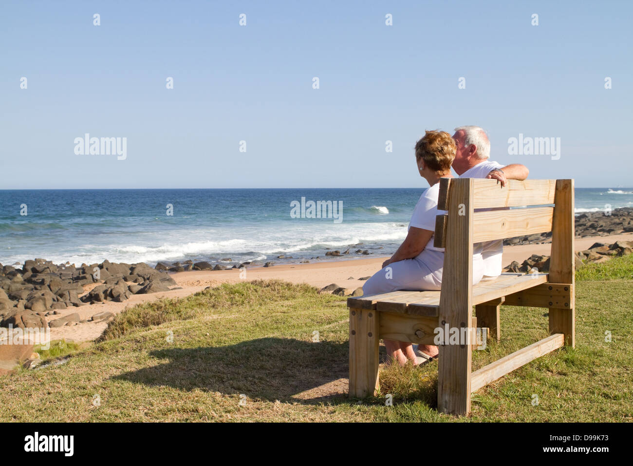 senior couple sitting on beach bench Stock Photo - Alamy