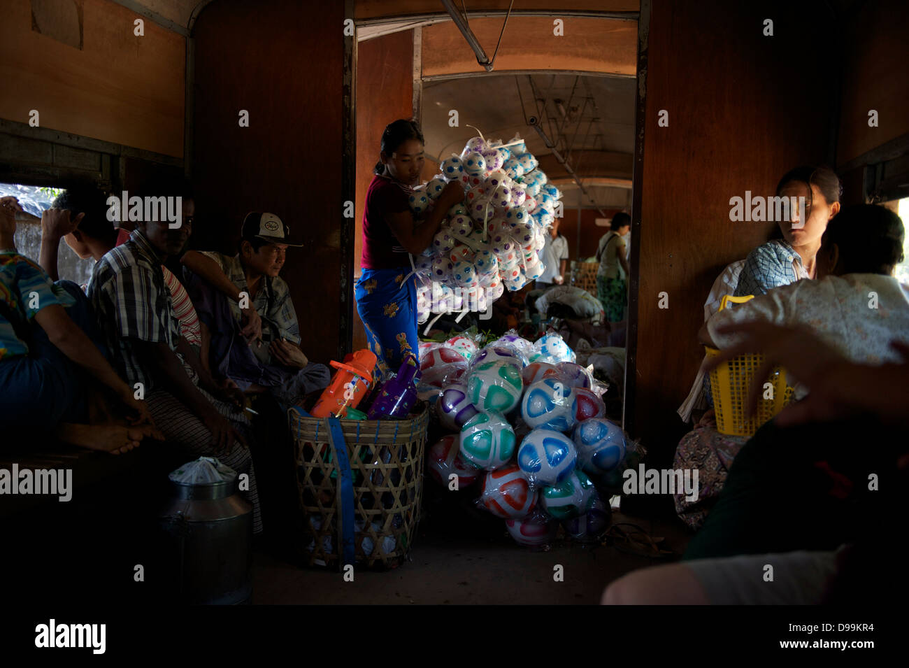 vendors carrying their merchandise inside the train in Yangon Stock Photo