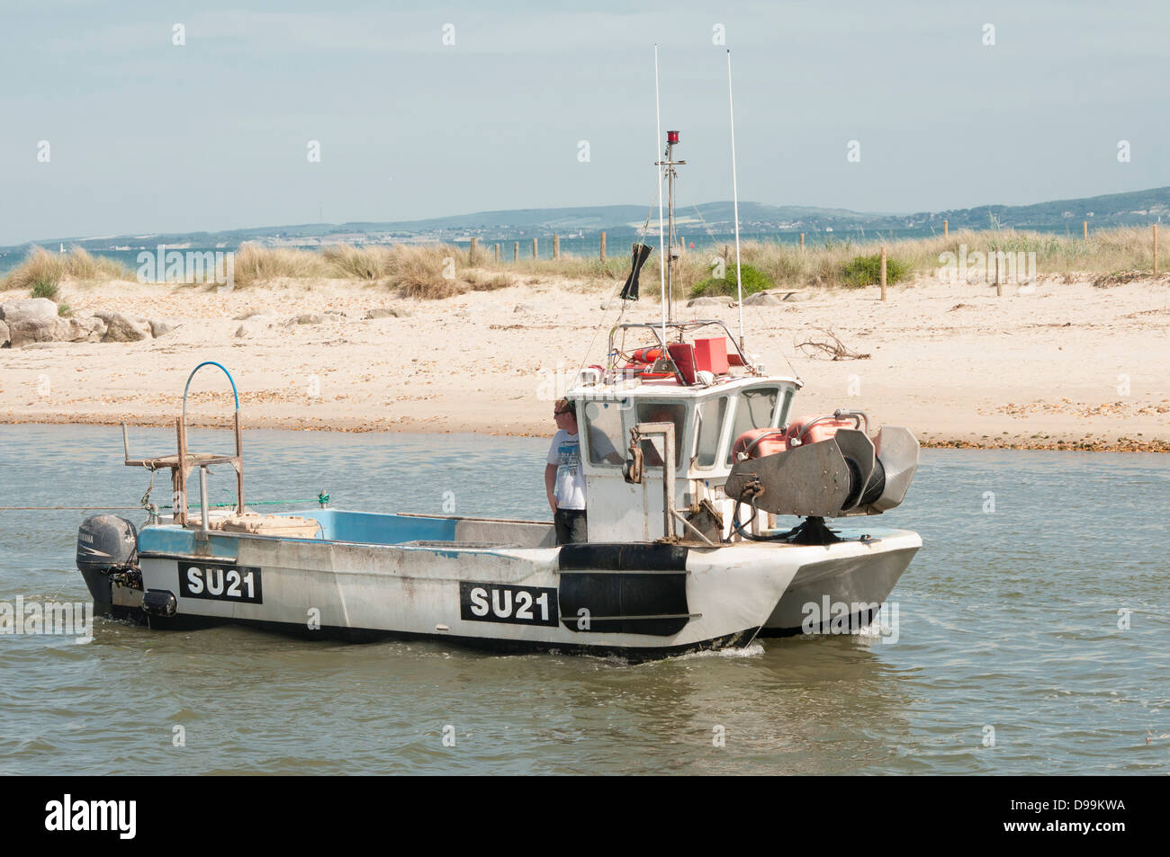 Fishing boat entering Christchurch Harbour in Dorset Stock Photo - Alamy