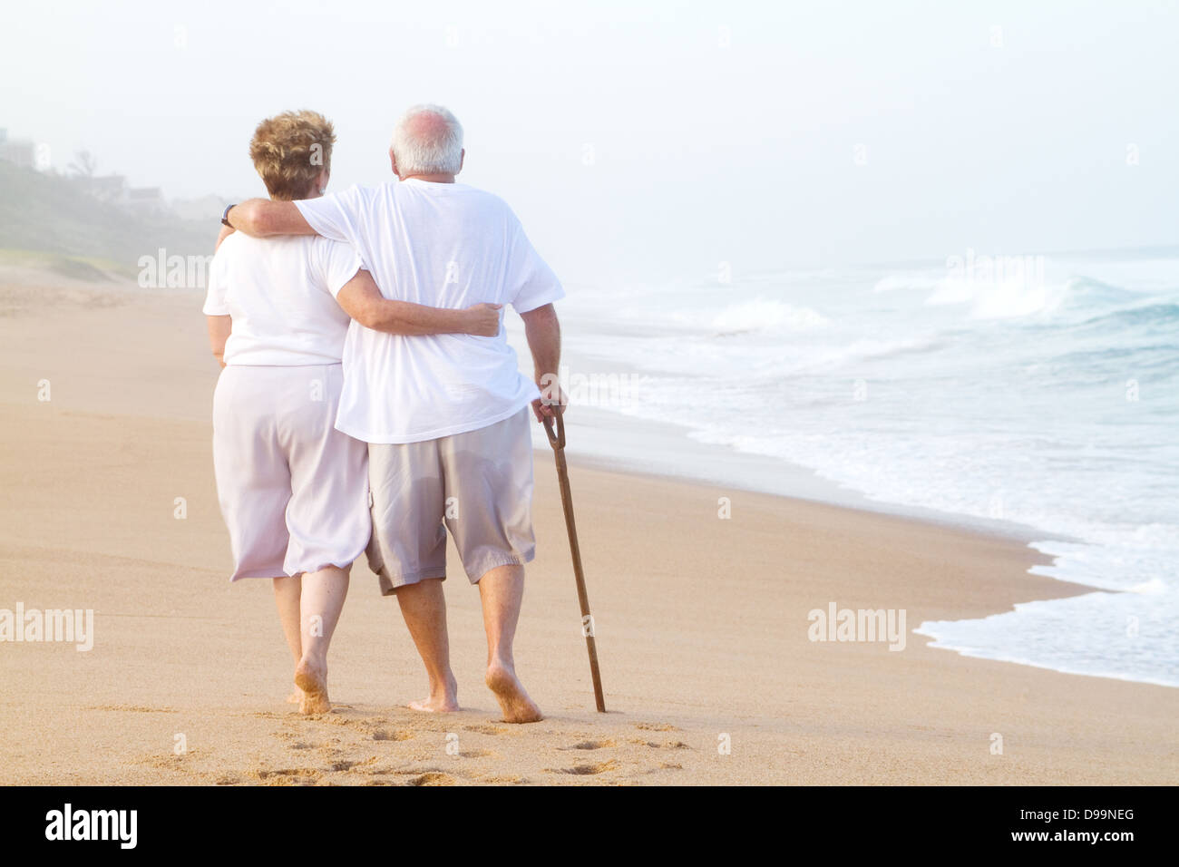 elderly couple walking on beach Stock Photo - Alamy