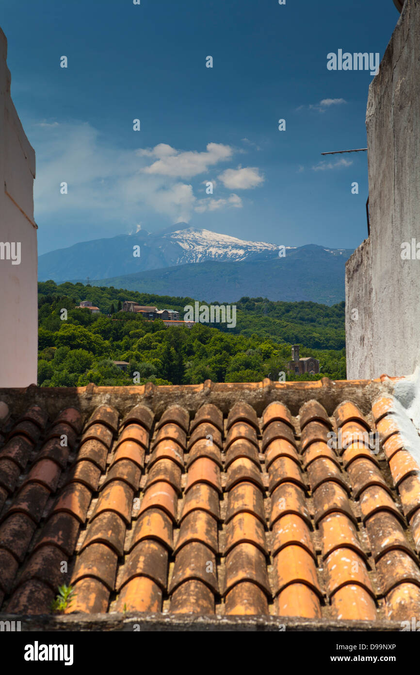 A rooftop of Castiglione di Sicilia with Mount Etna in the background ...