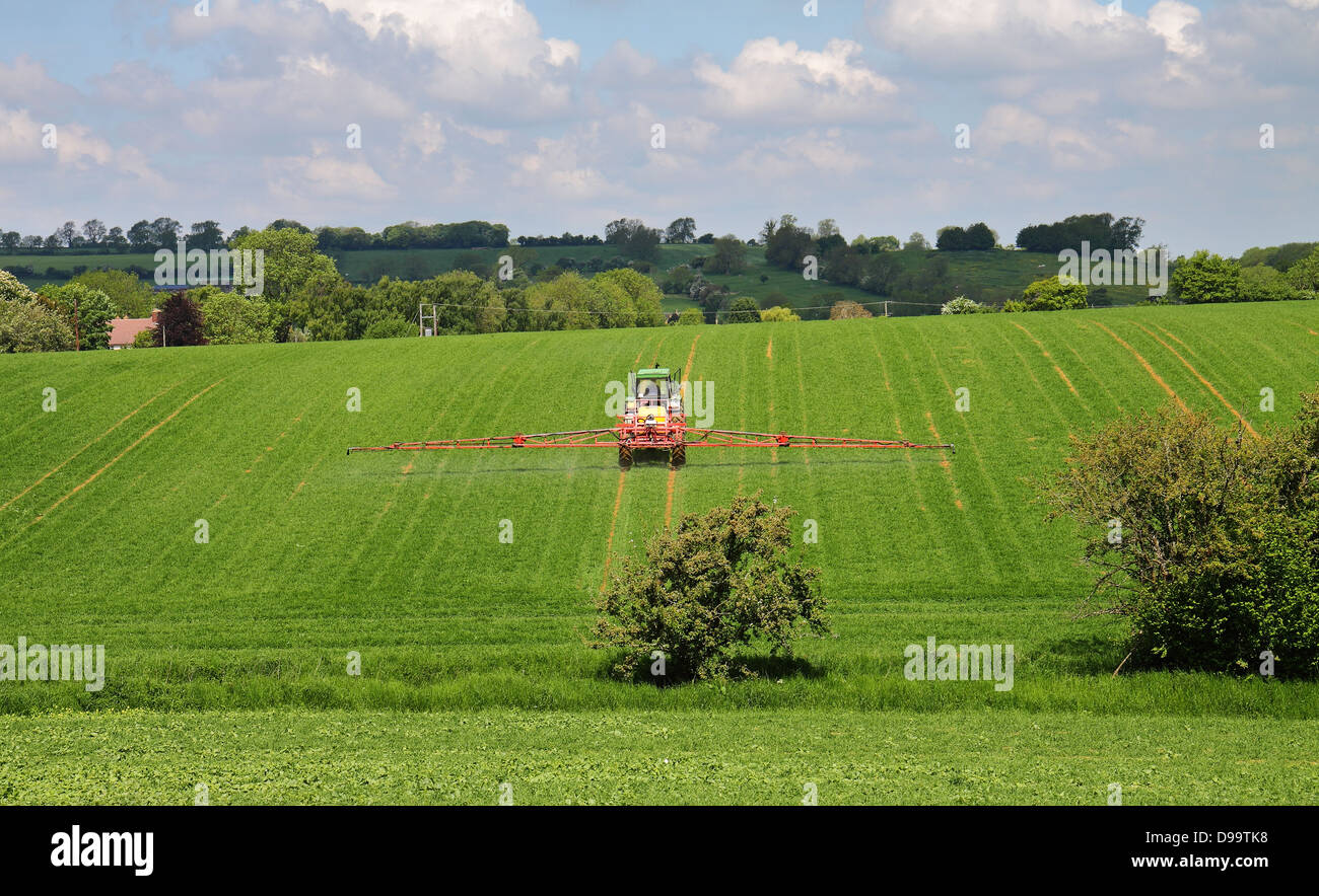 Crop spraying in an English Summer Landscape in the Cotswold Hills Stock Photo