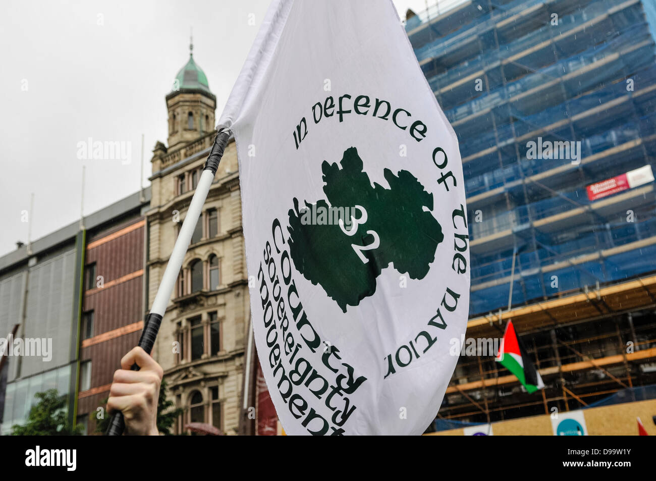 Belfast, Northern Ireland. 15th June 2013. The Irish Republican movement, the 32 County Sovereignty Committee hold their flag at an anti-G8 protest organised by the Irish Congress of Trade Unions (ICTU) Credit:  Stephen Barnes/Alamy Live News Stock Photo