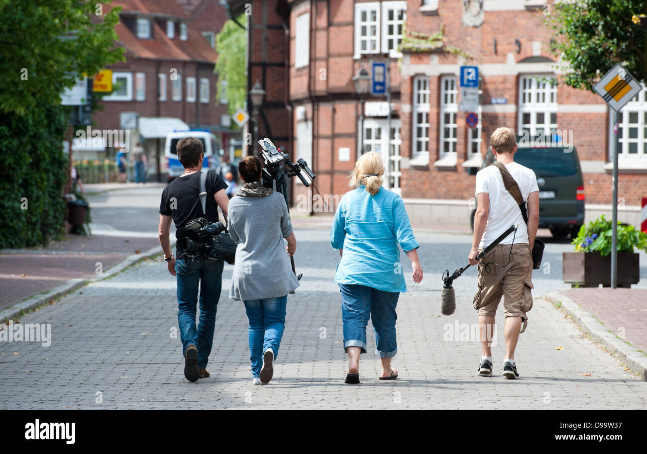 Journalists walk through the streets in Hitzacker, Germany, 15 June 2013. The flooding along the Elbe in north Germany is receeding. Photo: Philipp Schulze Stock Photo
