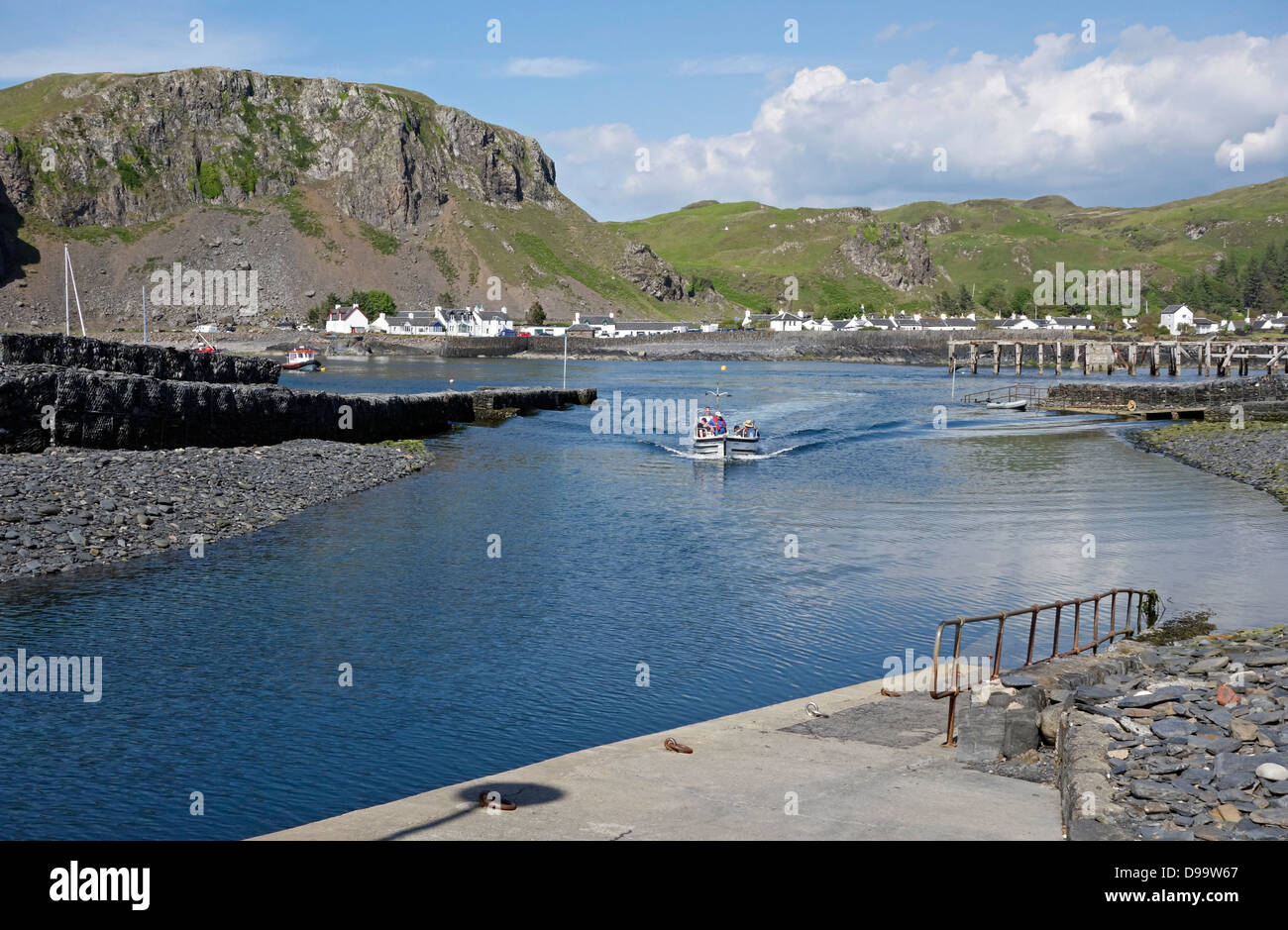The small passenger ferry is heading towards the Island of Easdale from Easdale town on the island of Seil in Scotland Stock Photo