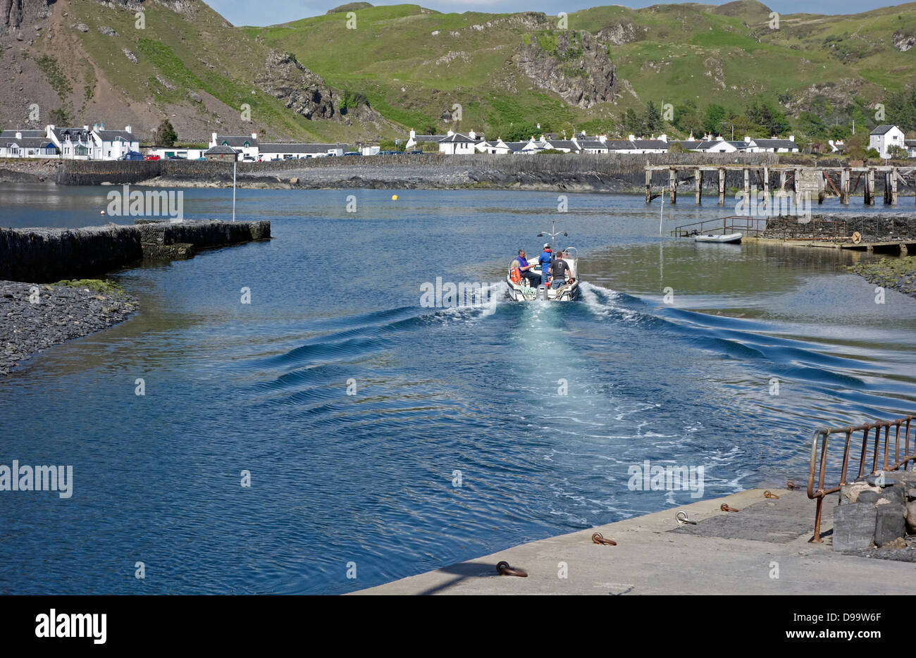 The small passenger ferry is leaving the Island of Easdale and heading towards Easdale town on the island of Seil in Scotland Stock Photo