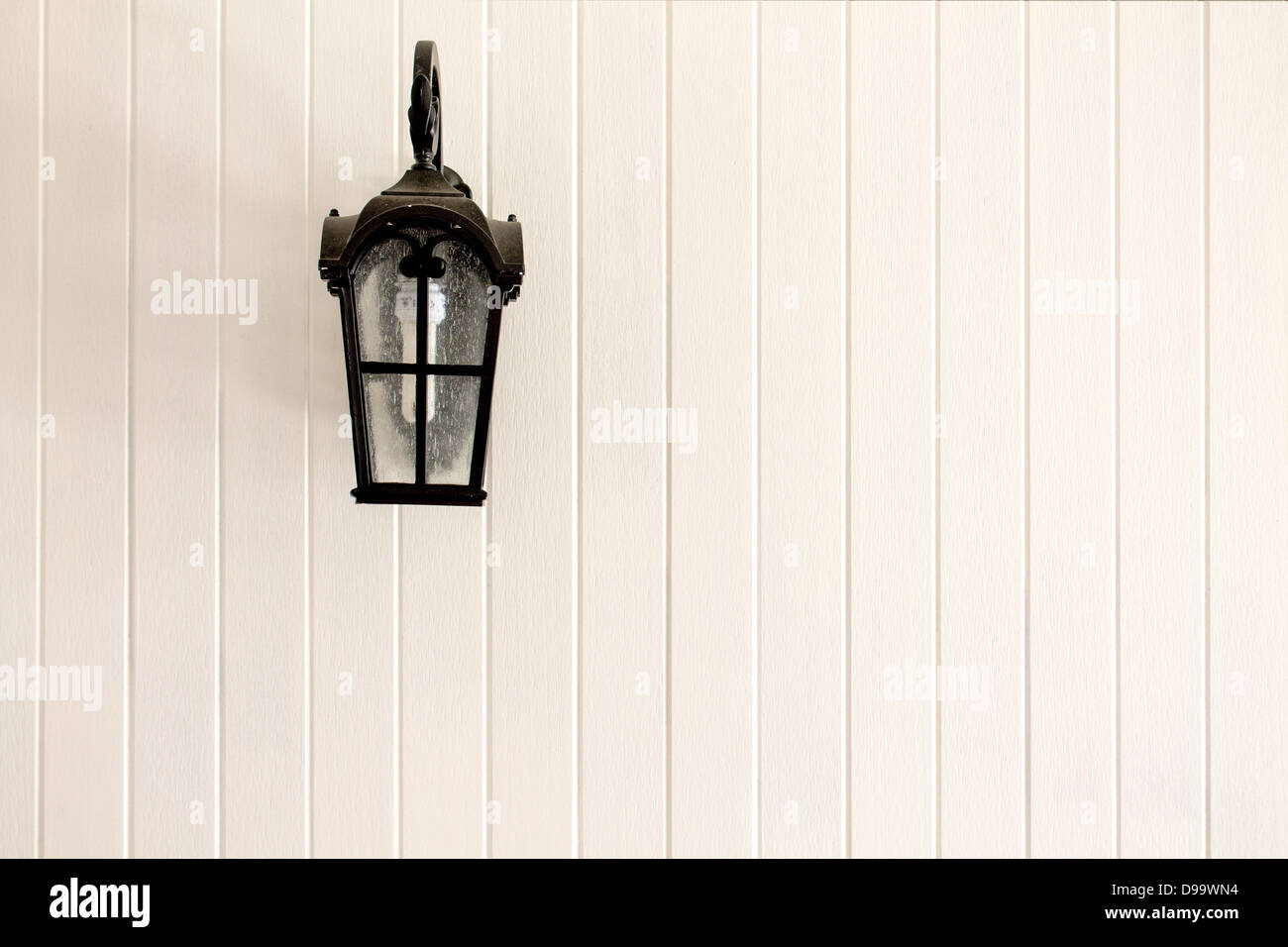 Black Lampposts on a white wall background. Stock Photo
