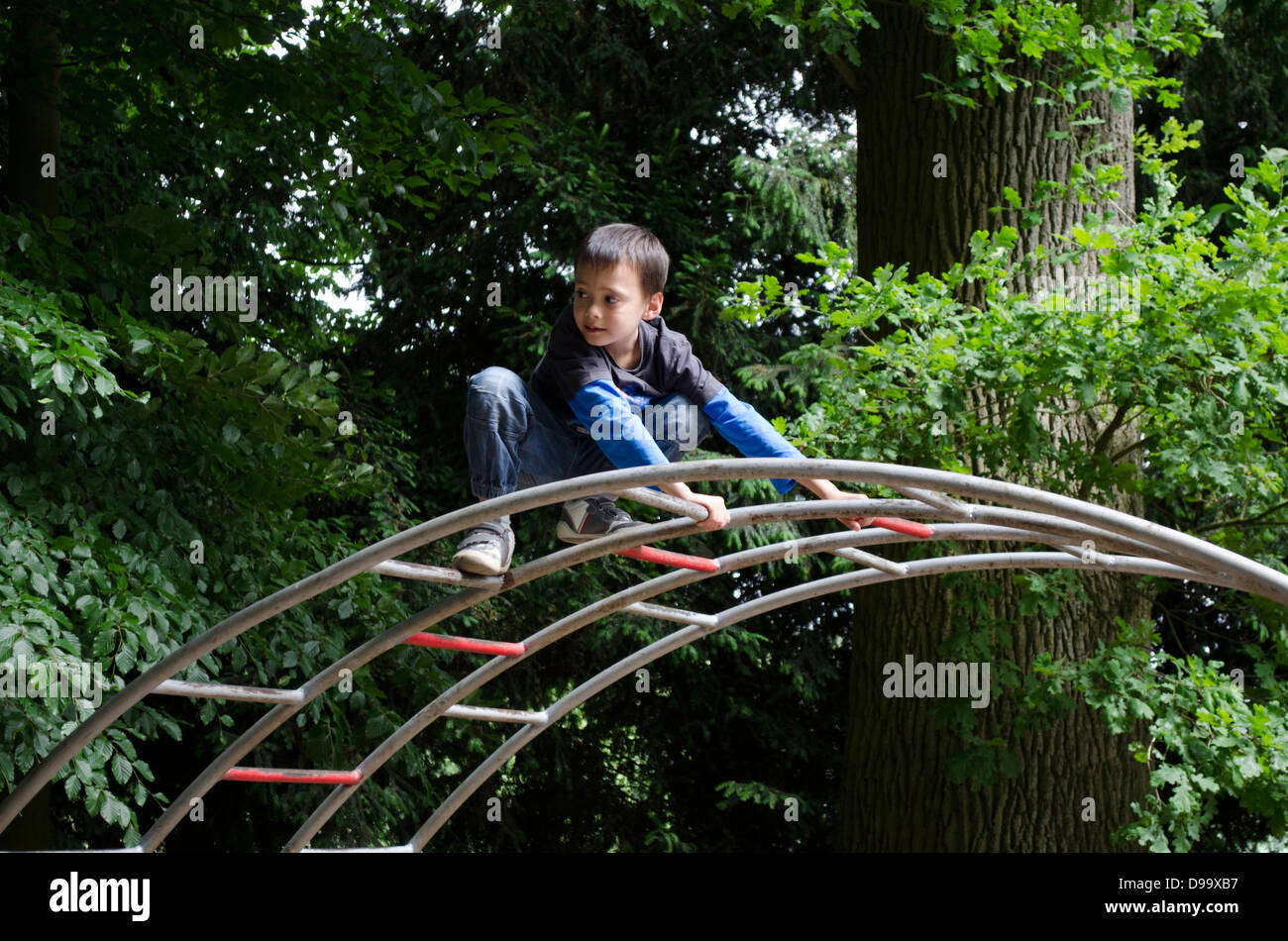 Young boy playing in playground Stock Photo - Alamy