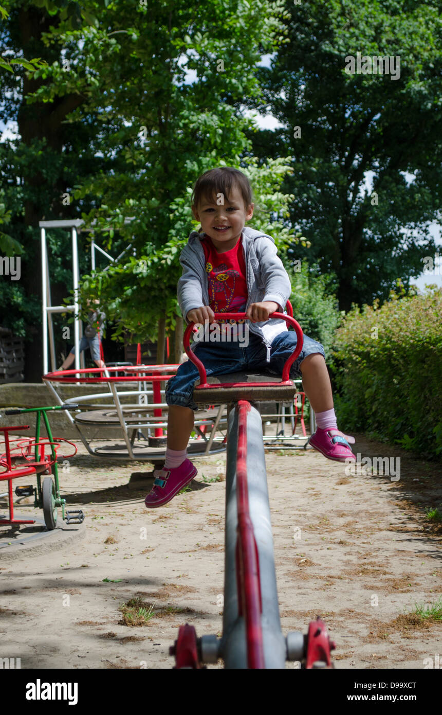 Young girl playing in playground Stock Photo - Alamy