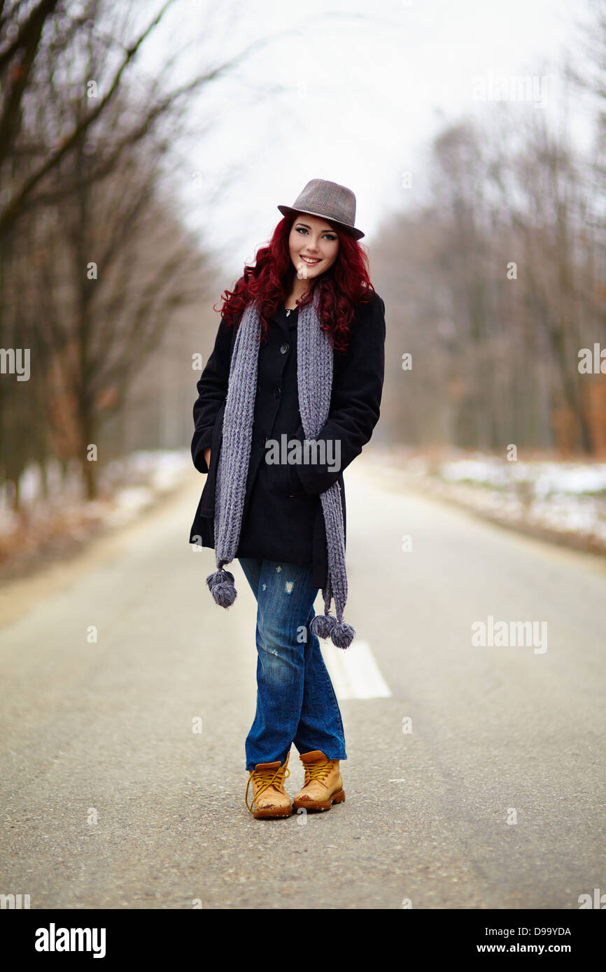 Happy girl in outdoor full length, hands in pockets Stock Photo - Alamy