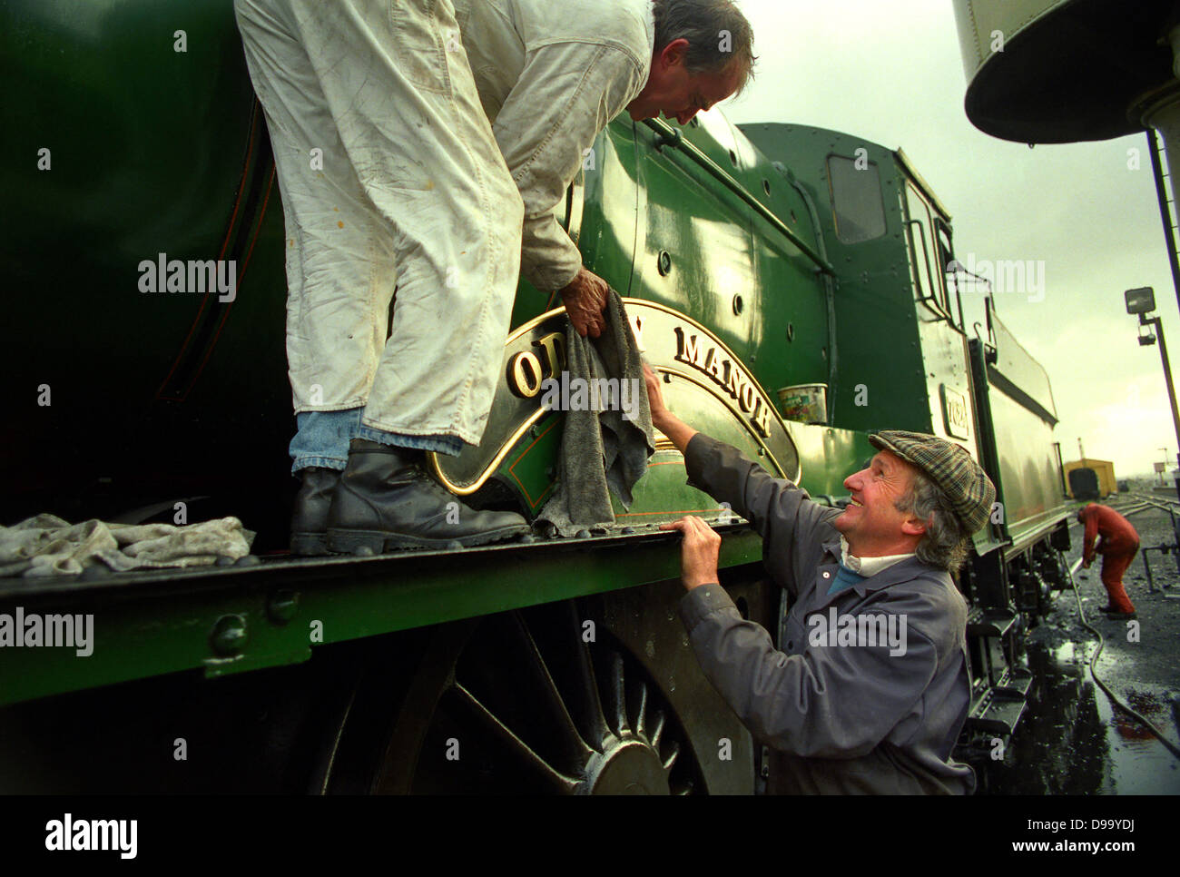 Steam engine being cleaned at West Somerset Railway in Minehead. Stock Photo