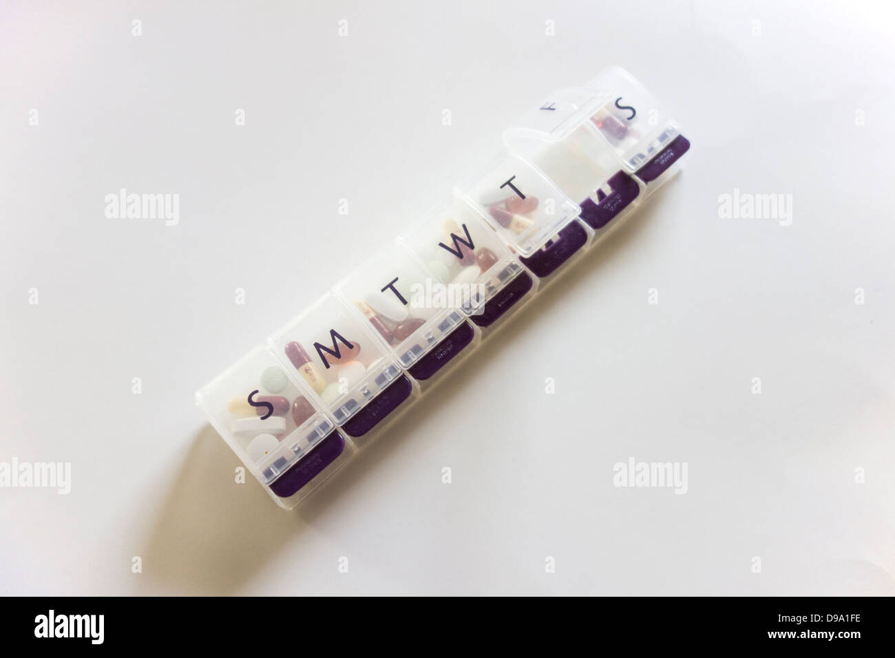 A week pill keeper with days of the week marked on each compartment ...